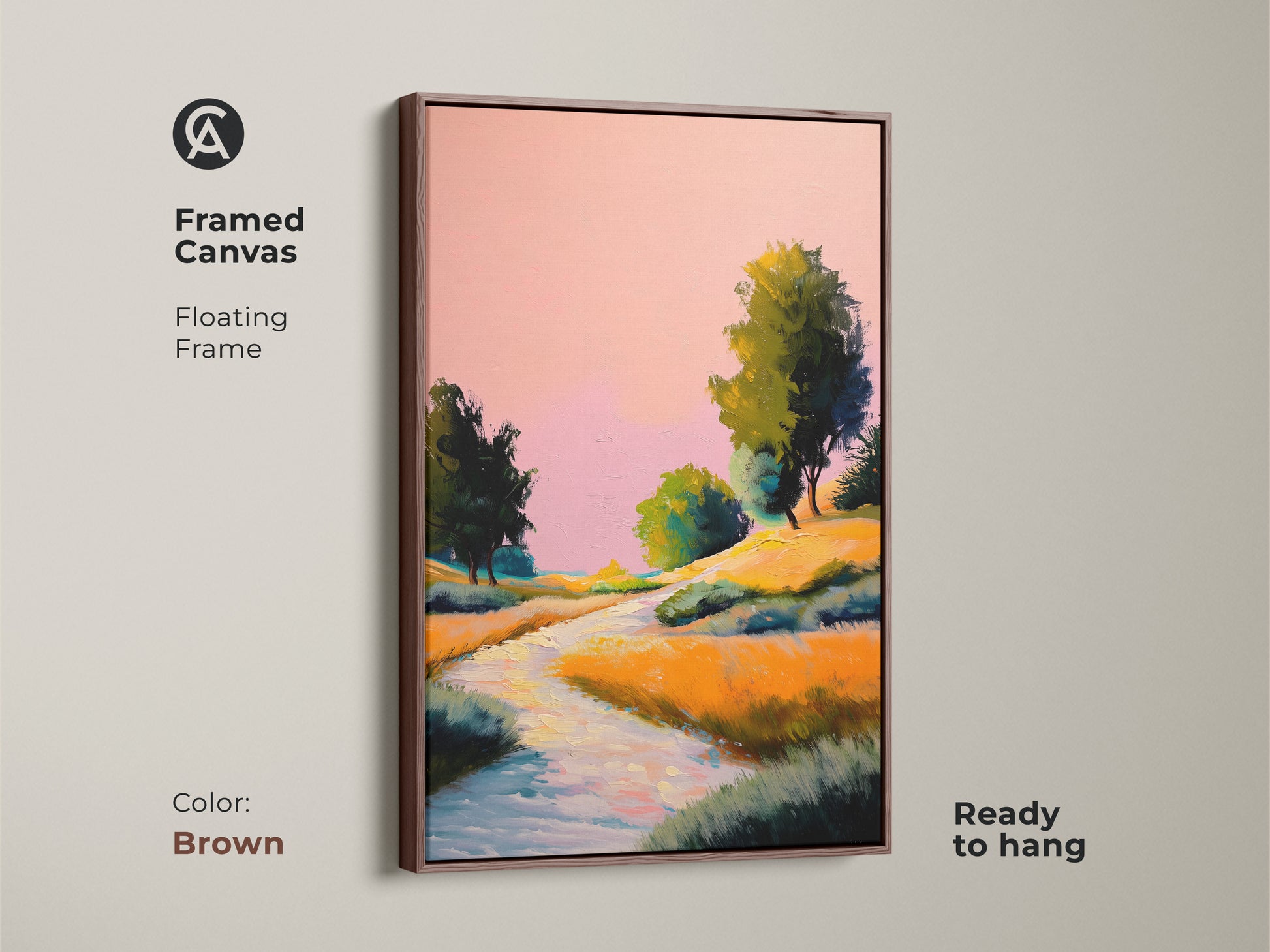 Brown framed canvas showcasing pink yellow and orange wall art. The expressive nature artwork with a boho river trees print is ready to hang. A countryside scenery artwork for nature lovers.