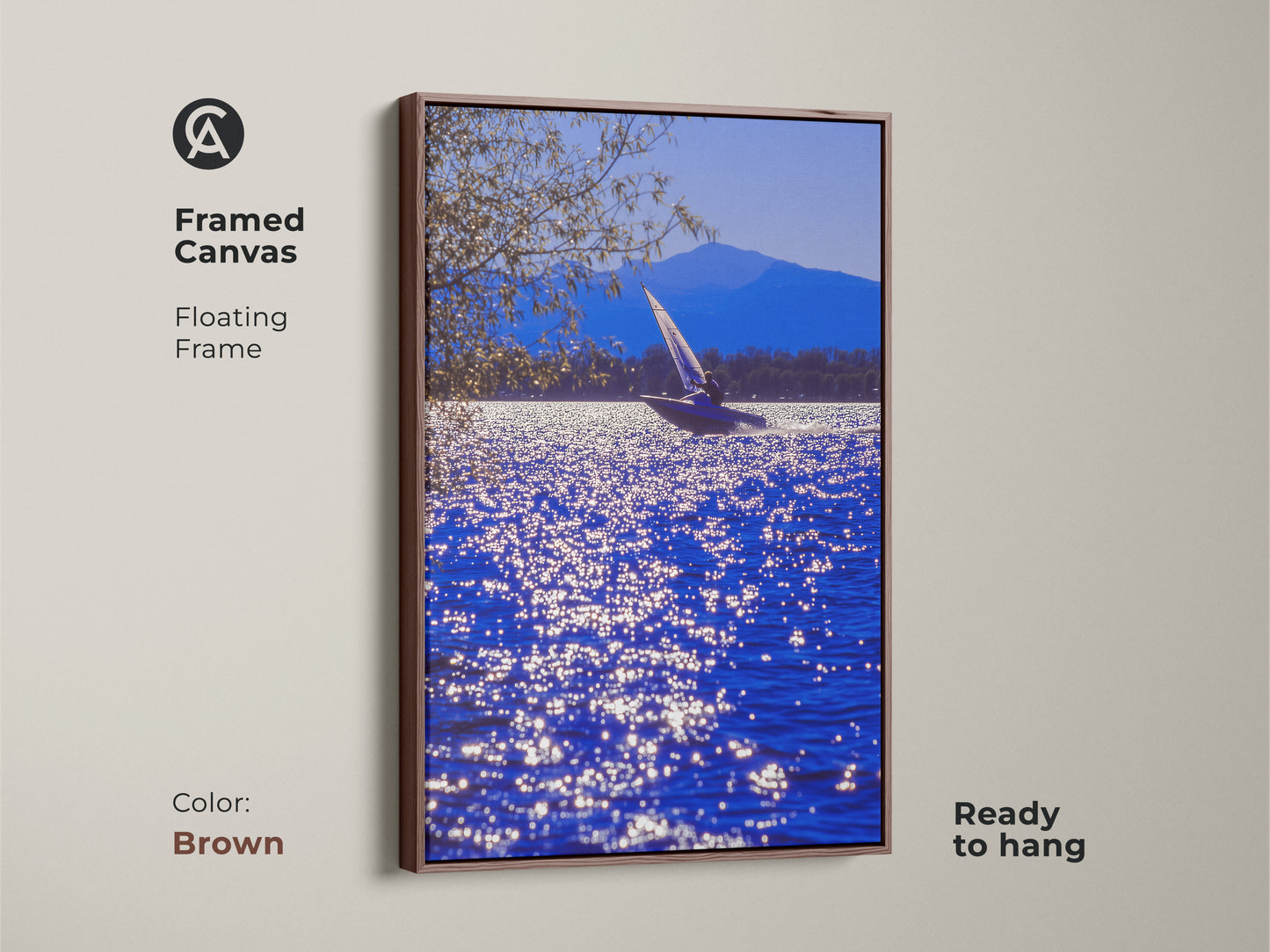 A framed canvas displays sailboat art on sparkling blue water. The brown floating frame complements this contemporary coastal artwork. This ready-to-hang nautical scene is ideal for residential wall decor. It makes a thoughtful housewarming gift.