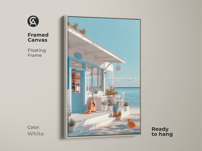 White framed canvas art print showing a peaceful beachside cafe. The floating frame complements the coastal artwork's calming tones. A ginger cat and guitar complete the scene. Ready to hang this canvas adds serenity to your home.