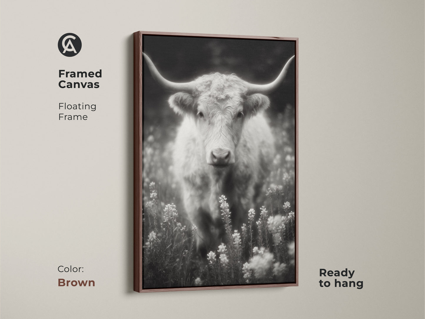 A brown framed canvas print of a longhorn in a field. The black and white artwork is ready to hang. The floating frame complements the rustic style. This fine art photograph is perfect for Western-themed decor.