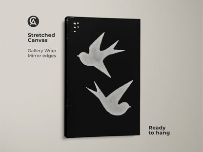 Stretched canvas featuring minimalist bird wall art. Abstract swallows print in black and white. Ready to hang for Scandinavian bedroom decor. Modern folk art print adds a touch of nature. The gallery wrap has mirrored edges.
