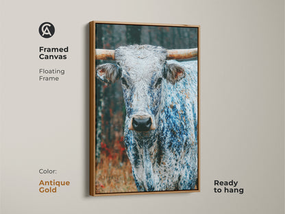 Framed canvas art featuring a Longhorn. The floating frame is antique gold. This ready-to-hang piece offers a touch of elegance. The animal's features are beautifully rendered. It is a luxurious addition to any space.