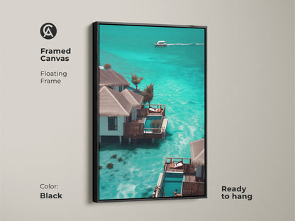 Framed canvas with a black floating frame featuring a luxury tropical resort bungalow. Teal and blue ocean hues create a coastal beach house aesthetic. This overwater bungalow art is ready to hang adding paradise to your home. The perfect modern coastal wall art.
