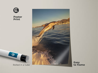 Museum-quality paper art print of a dolphin jumping from ocean waves. Easy to frame and rolled in a protective tube. Golden yellow sunlight enhances this coastal artwork. Ideal for beach house decor or as a thoughtful gift for marine animal art lovers. This print brings a sunny ocean scene to any room.