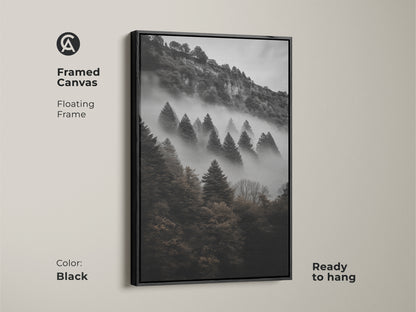 Black framed canvas featuring a dark green forest. Floating frame monochrome mountain wall art. Pine trees in a foggy landscape create a tranquil scene. Ready to hang modern nature art. This atmospheric forest canvas is perfect dark nature artwork.
