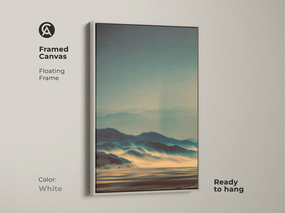 Framed canvas art with a floating frame in white. The artwork features a misty mountain landscape. This ready-to-hang piece offers a clean modern look. Its serene view enhances any room. The subtle colors create a calming atmosphere in your space.