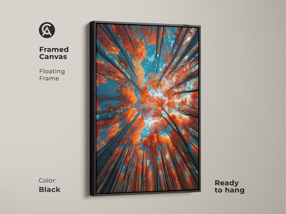 A framed canvas artwork with a black floating frame. The art shows tall trees from a low angle. The leaves are orange and the sky is blue. This ready-to-hang art adds elegance to any room. Enhance your decor now