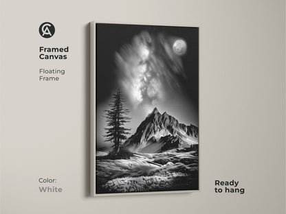 A white framed canvas features monochrome mountain art. The floating frame showcases a black and white landscape with a moonlit pine tree. This contemporary nature artwork is ready to hang.