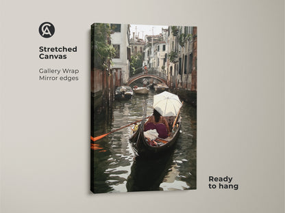 Stretched canvas art print of a Venice canal watercolor painting. This Italian cityscape wall art features gallery wrap mirror edges and comes ready to hang. The artwork displays a gondola boat scene in teal and brown tones perfect for eclectic home decor.