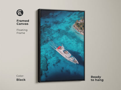 Black framed canvas artwork of a luxury yacht sailing on crystal turquoise waters near a tropical island. The floating frame enhances the art creating a sophisticated look. This ready-to-hang piece adds a nautical touch to any room. Ideal for those seeking elegant coastal-themed wall decor.
