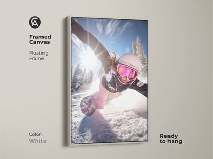 Framed canvas of a snowboarder in action. The white floating frame offers a clean look. This dynamic winter sports print is ready to hang. Ideal wall art for contemporary home decor.