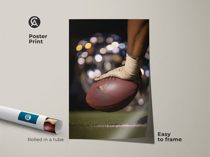 This poster print captures a football action shot. Rolled in a tube it's easy to frame and display. The print features contemporary brown and green tones. It is ideal for sports room wall decor. It is a perfect gift for a sports fan wanting to showcase their passion.
