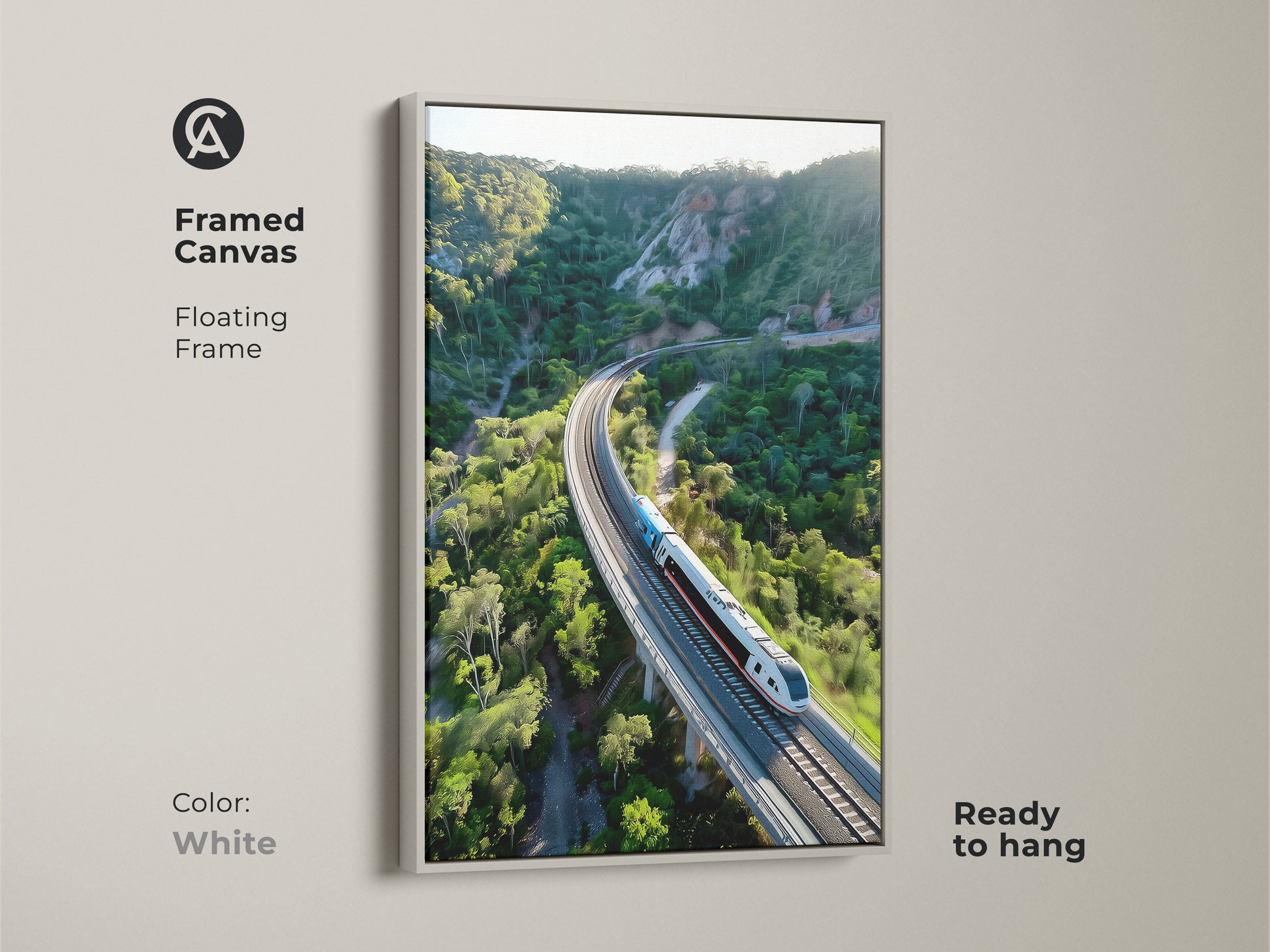 Modernize your space with this framed canvas print. The aerial train artwork features a white floating frame. This contemporary piece showcases a green mountain landscape. It is ready to hang. This nature inspired artwork brings a fresh feel to any room. Ideal for contemporary decor styles.