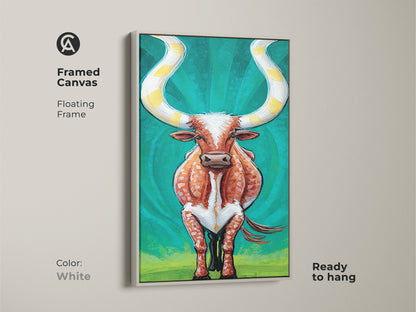 Framed canvas artwork of an expressive longhorn cattle. The floating frame is white. It's ready to hang. The orange and teal hues of this animal print bring a modern touch to ranch style homes. Elevate your wall decor with this unique piece.