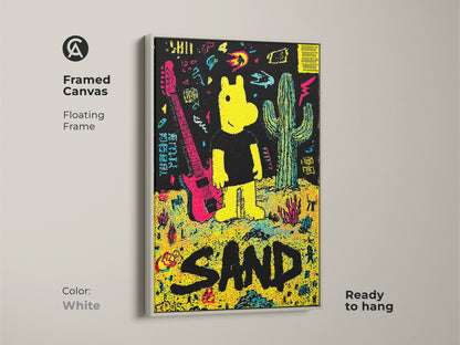 Framed canvas art print showcasing a yellow cartoon figure guitar and cactus against a black backdrop. The artwork spells out the word SAND in large black letters. This white floating frame canvas is ready to hang.