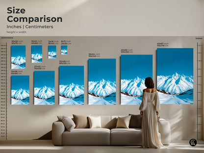 Size comparison of abstract snowy mountain art prints. See how different sizes of this deep blue sky canvas art look above a sofa. Perfect for adding a contemporary touch to your living room.