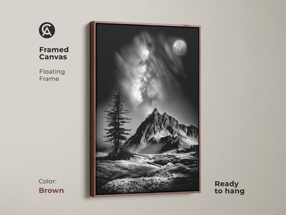 A brown framed canvas showcases monochrome mountain art. This floating frame features a black and white landscape with a moonlit pine tree. It's a ready to hang nature wall art decor piece.