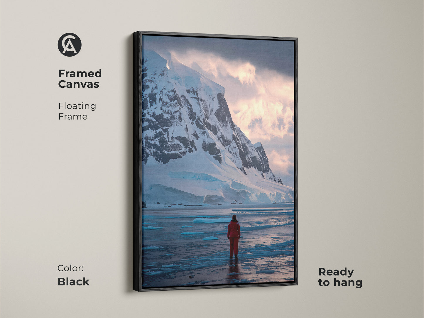 Framed canvas of Antarctica with a black floating frame. This ready to hang wall art features a solitary explorer in a red suit against snowy mountains and icy waters. Modern blue ice artwork.