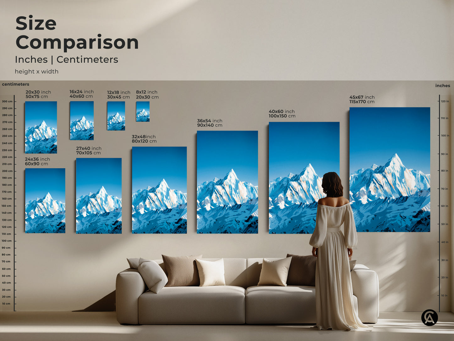 Size comparison for snowy mountain art in inches and centimeters. Various sizes are displayed above a sofa. This landscape canvas art is perfect for any space. See how this blue white landscape art will look in your home.