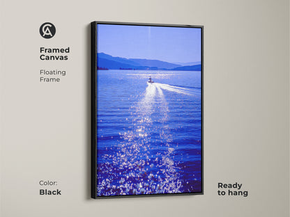 Framed canvas of a speedboat art on a deep blue lake. The floating frame is black and ready to hang. This scenic wall artwork is a great housewarming gift for travel enthusiasts. It's a perfect piece of modern art.
