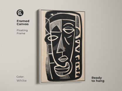 Framed canvas print of a black white and beige abstract face. This floating frame has a white finish and is ready to hang. The modern figurative portrait is an ideal piece for eclectic home decor complementing modern wall art trends.