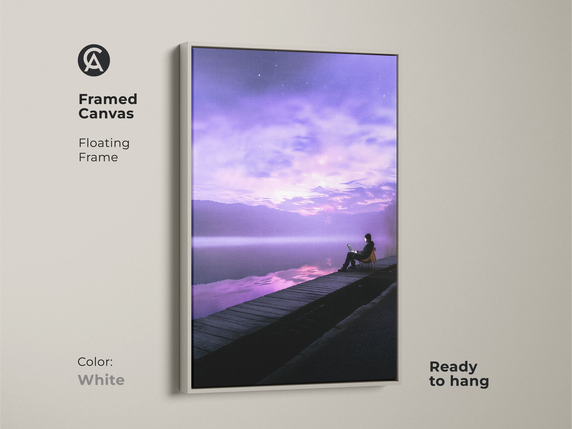 Framed canvas print of a surreal scene with a person working on a laptop. The floating frame is in white. This violet skyscape artwork creates a dreamy dock scene. It is ready to hang. Perfect for adding a modern touch to any office.