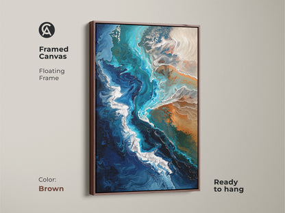 Framed canvas in brown featuring abstract coastal artwork. The floating frame enhances the teal blue and sandy beige fluid art. Ideal wall art for beach themed rooms.