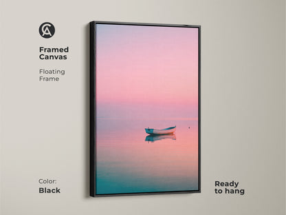 Framed canvas art featuring a boat on calm water. The floating frame is black. This coastal artwork is ready to hang. A peaceful and serene fine art print for your home.
