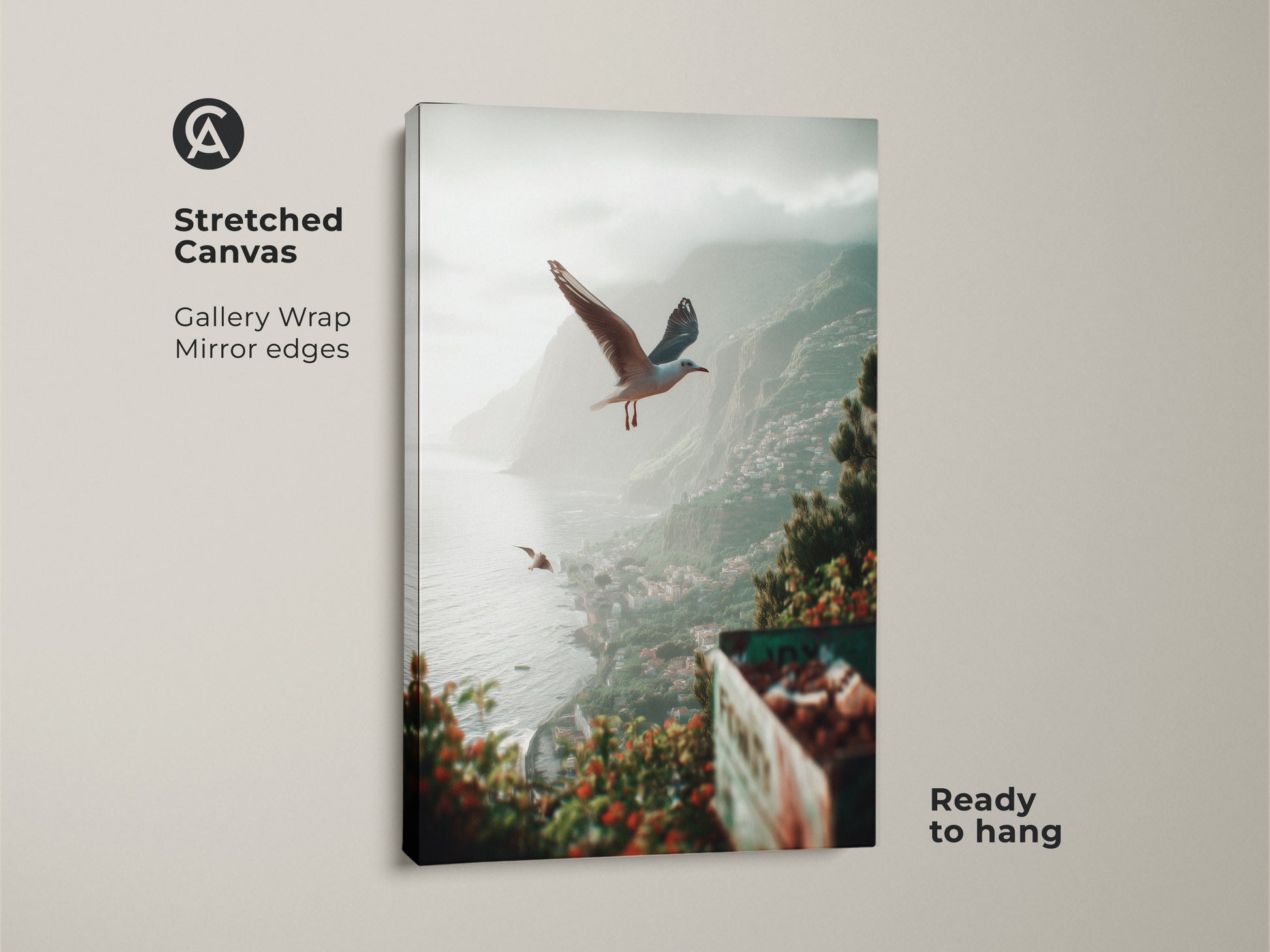Close up of teal green grey artwork on stretched canvas with seagulls flying over a seaside town. This coastal landscape art is ready to hang offering a gallery wrap with mirror edges. This beach town canvas print is a perfect tranquil ocean art and housewarming gift.