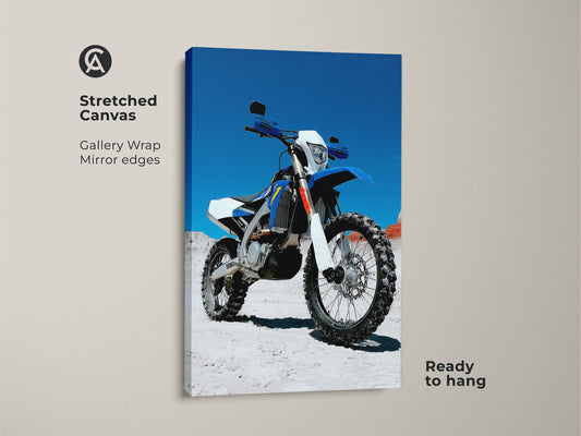 Stretched canvas featuring motocross motorcycle art. This blue and white dirt bike art is gallery wrapped with mirror edges. Ready to hang for instant garage man cave decor. Ideal for motorcycle enthusiasts who love off road vehicles.