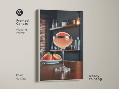 White framed canvas print of a grapefruit and peach cocktail. This floating frame enhances the modern bar art making it ready to hang. Ideal as Scandinavian kitchen decor or cafe wall art. Perfect as a housewarming gift for cocktail enthusiasts.
