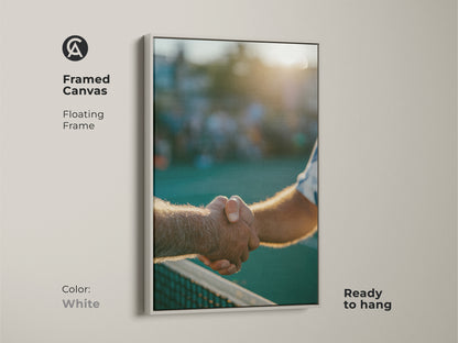 White framed canvas art featuring a handshake after a tennis game. The clean floating frame complements the image. This ready-to-hang artwork adds a modern touch. A perfect addition to your art collection.