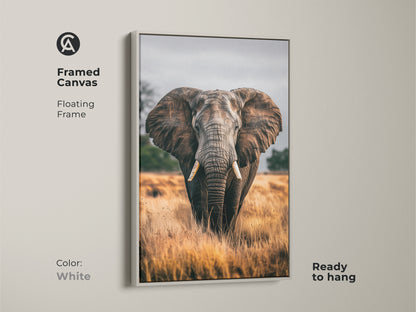 Framed canvas of an elephant portrait in white. This wildlife wall art features a floating frame. The earthy brown and grey tones bring a rustic touch to your living room or bedroom. This ready to hang canvas is a perfect housewarming gift. The photorealistic animal is showcased in its natural habitat.