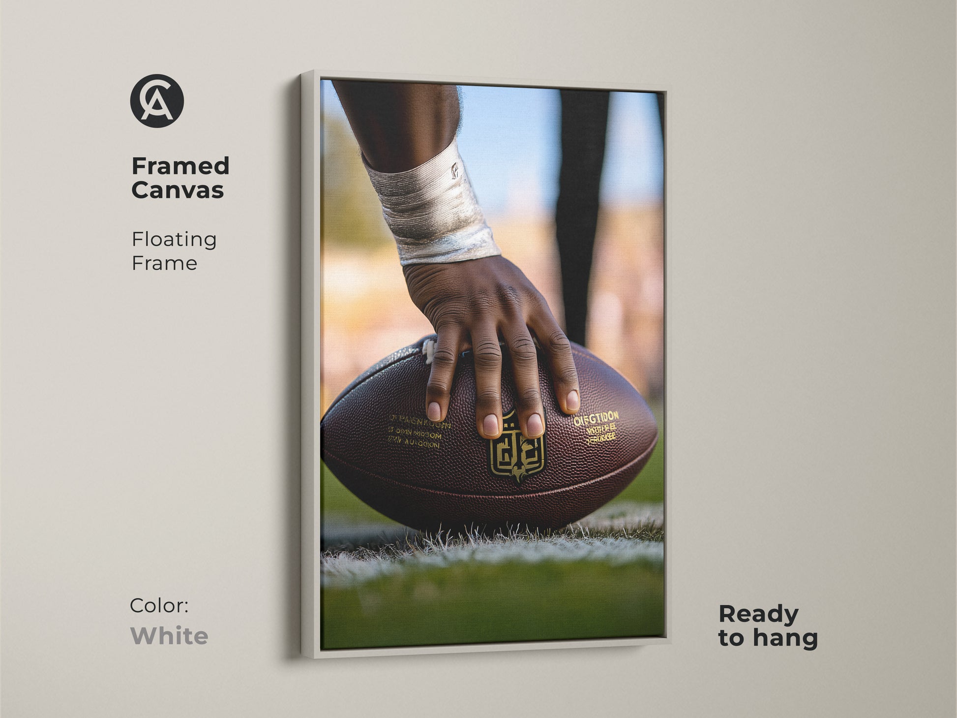 Framed Canvas Print of American Football Action. The artwork has a floating frame in white. The image is of a player's hand holding the football. Ready to hang instantly. This sports themed gift is great for any room. Perfect for football season wall art.