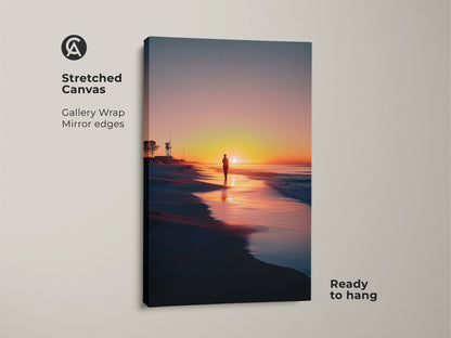 Stretched canvas of a beach sunset wall art showcases a lifeguard tower. A solitary walker creates a calm landscape. The gallery wrap has mirror edges and is ready to hang. Perfect coastal decor for any home. The orange yellow pink hues add warmth.