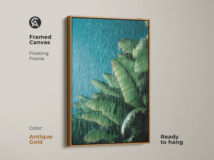 Antique gold framed canvas print of tropical banana leaves in rain. The green botanical wall art is ready to hang. Floating frame enhances the moody green teal artwork. This boho plant lover gift adds sophistication to any room. Ideal for creating a calming home environment with nature-inspired art.