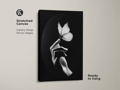A stretched canvas showcases monochrome butterfly art. A minimalist hand art print adds elegance. Black and white wall decor is featured. It is ready to hang and is perfect as nature lover gift art. Great contemporary bedroom art. A striking insect macro print is captured. Consider this fine art canvas print for a minimalist living room. It is ideal as a butterfly wall hanging for modern office art
