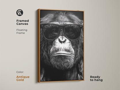A framed canvas features a chimpanzee wearing sunglasses. The antique gold floating frame enhances this monochrome gorilla art. It's ready to hang for study room or office decor. Perfect eclectic animal art for an animal lover gift. This primate portrait is a unique wall hanging.