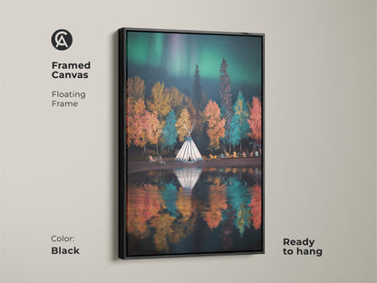 Framed canvas art of a tipi camp under the aurora borealis with a black floating frame.  Ready to hang this autumn forest scene features emerald green and teal hues. Boho nature landscape artwork adds a dreamy touch to any room.