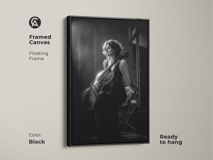 Framed canvas featuring a black and white cellist portrait. This contemporary music artwork is ready to hang. A floating frame adds sophistication to this musician gift. Perfect for home studio wall decor or a music room. The black frame enhances the monochrome artwork.