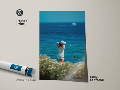 Golf poster print for wall decor. This poster features a female golfer teeing off. She is with the ocean in the background. This golf artwork is easy to frame. It arrives rolled in a protective tube for safe shipping.