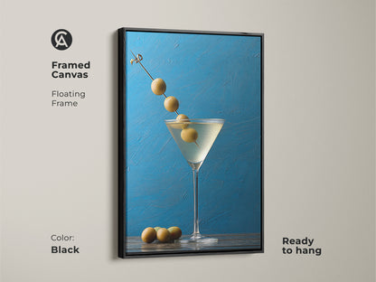 Framed canvas with a black floating frame showing a martini artwork. This still life artwork is ready to hang. Perfect for modern bar artwork or blue kitchen decor. It is a contemporary gift featuring an olive garnish. The azure blue background enhances home bar decoration.