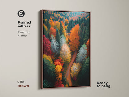 Brown framed canvas print showcasing a colorful forest. This ready-to-hang artwork features an aerial view of trees in autumn. The warm brown frame enhances this landscape art. Perfect for nature-inspired home decor.