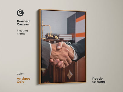 Framed canvas featuring handshake artwork perfect for a lawyer gift. Floating in an antique gold frame it showcases scales of justice. Ready to hang this contemporary office art symbolizes a business agreement. Ideal for legal offices this dark brown and grey art promotes partnership and trust. Elevate your professional space with this sophisticated office decor.