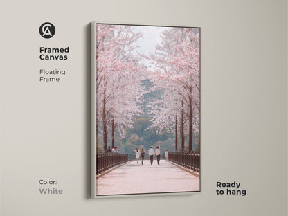 Enhance your space with this framed canvas art. A white floating frame highlights a couple walking under cherry blossoms. This contemporary nature art adds elegance to any room. Ready to hang this romantic spring scene brings seasonal beauty to your home.