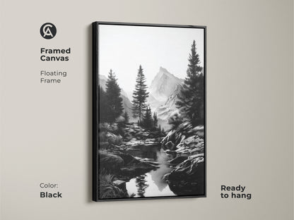 A framed canvas with a floating frame featuring a black and white mountain river art print. Monochrome artwork shows a rustic pine tree landscape. Ready to hang this minimalist nature wall decor complements any space. It is a perfect gift for hikers.