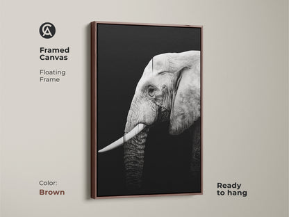 Framed canvas with a brown floating frame displays a monochrome elephant. This wildlife artwork enhances any home decor. It is a perfect gift for animal lovers and adds a touch of elegance.