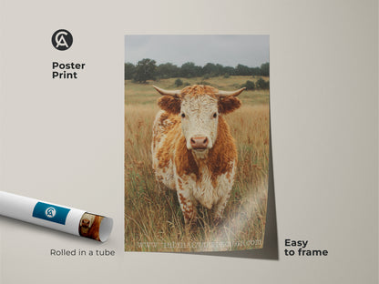 A poster print features a cow standing in a field. The poster is rolled in a tube and easy to frame. The artwork captures a close up of the animal in natural tones. This cow art is ready to display.