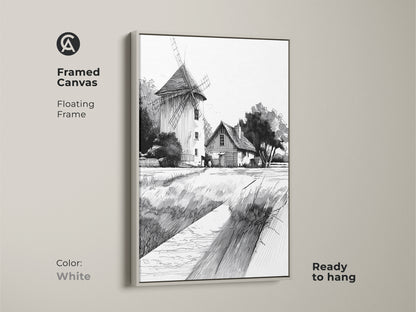 Framed canvas displaying farmhouse windmill art in a white floating frame. The black and white ink drawing provides a clean look to the country landscape. This ready-to-hang art enhances farmhouse kitchen wall decor.