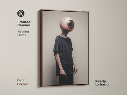 Framed in brown this canvas art features a surreal eyeball head. The conceptual figure art with its dark aesthetic enriches eclectic decor. Ready to hang this piece is perfect for adding depth. This unique office art is ideal as a brown beige art lover Halloween gift.
